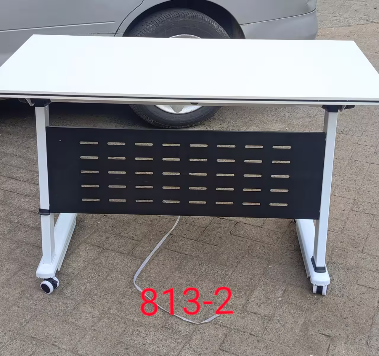 Mobile Training Table with white tabletop, perforated modesty panel, and caster wheels designed for training rooms, classrooms, and modern office workspaces.