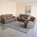 6 seater recliner sofa set with brown upholstery, plush cushioned seats, padded backrests and wide armrests in a modern living room.