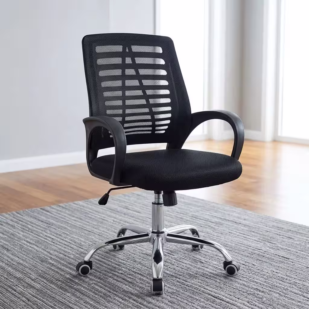 A black premium mesh mid-back ergonomic office chair with a polished chrome base and casters, positioned on a grey textured rug in a modern office with windows and a wood floor.
