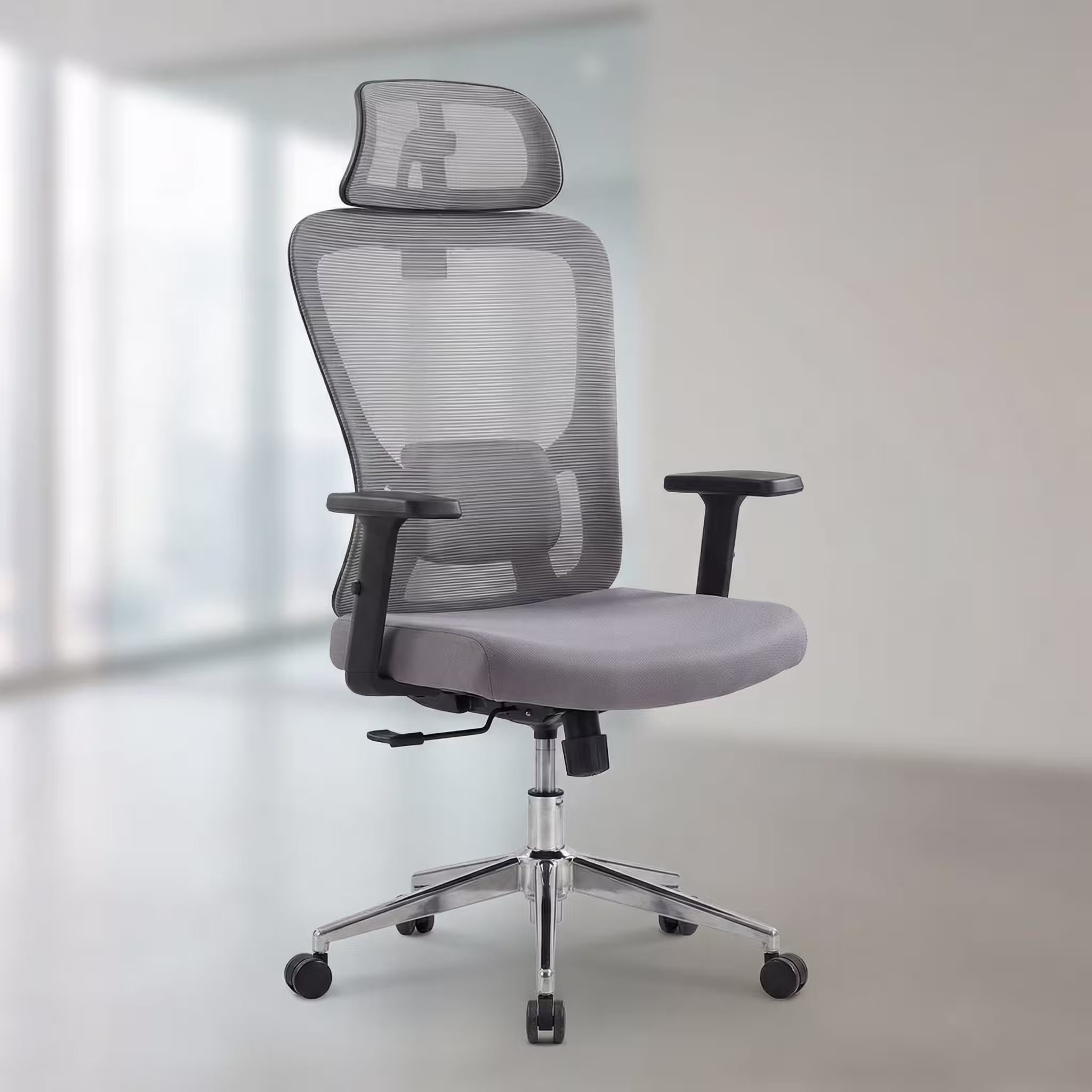 Grey orthopedic office chair with adjustable headrest, breathable mesh backrest, lumbar support, padded seat, and chrome swivel base