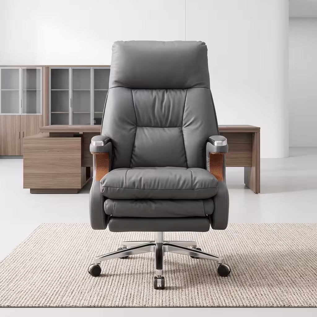 Executive leather office chair with reclining backrest, extendable footrest, padded armrests, chrome base, and premium grey upholstery.
