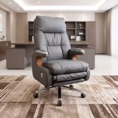 Executive leather office chair with reclining backrest, extendable footrest, padded armrests, chrome base, and premium grey upholstery.