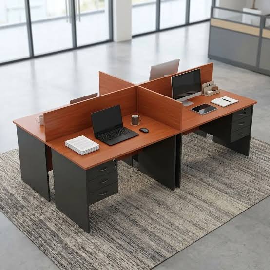 Customized 4 way workstation with privacy partitions, drawer pedestals, cable management ports, and four individual workspaces.